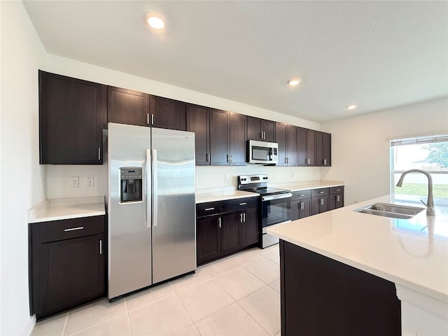 1138 Calico Pointe Cir, Groveland, FL 34736 - kitchen with appliances with stainless steel finishes, light countertops, dark brown cabinetry, light tile patterned floors, and recessed lighting