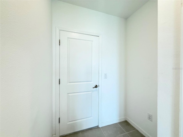 1138 Calico Pointe Cir, Groveland, FL 34736 - spare room featuring dark tile patterned floors and baseboards