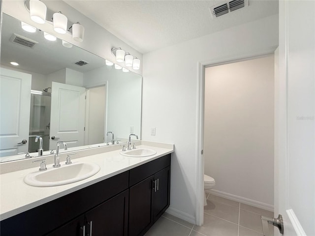 1138 Calico Pointe Cir, Groveland, FL 34736 - full bath with double vanity, tile patterned floors, and a shower with shower door