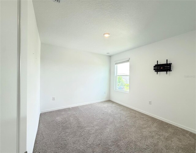 1138 Calico Pointe Cir, Groveland, FL 34736 - spare room featuring carpet flooring and a textured ceiling