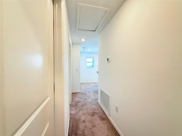 1138 Calico Pointe Cir, Groveland, FL 34736 - hallway featuring attic access and light carpet