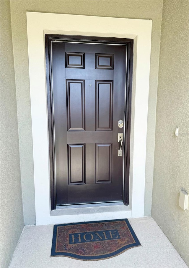 1138 Calico Pointe Cir, Groveland, FL 34736 - doorway to property featuring stucco siding