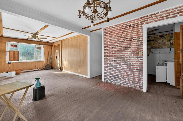 54544 Buckhorn Rd, Astor, FL 32102 - unfurnished living room featuring wood-type flooring, a ceiling fan, a chandelier, wood walls, and beamed ceiling