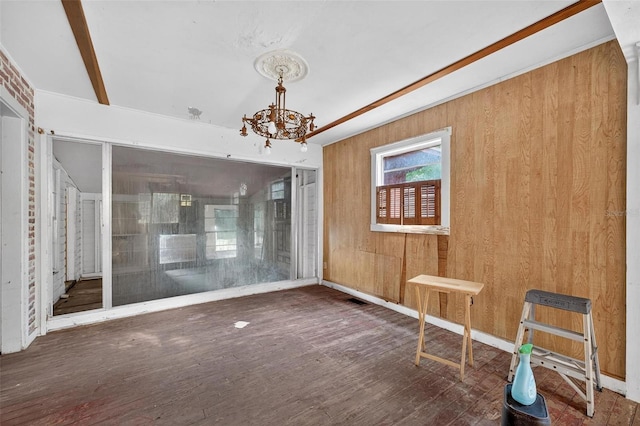 54544 Buckhorn Rd, Astor, FL 32102 - spare room featuring a chandelier, wood finished floors, and wood walls