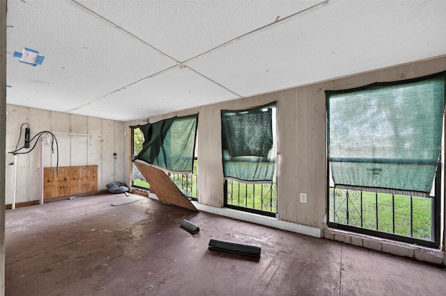 54544 Buckhorn Rd, Astor, FL 32102 - unfurnished room featuring wooden walls and a textured ceiling