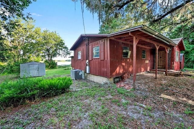 54544 Buckhorn Rd, Astor, FL 32102 - view of side of property featuring a storage unit and board and batten siding
