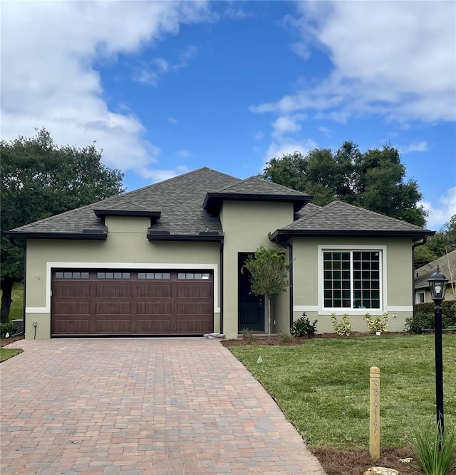 0 Sunbeam Way, Lady Lake, FL 32159 - view of front of property with stucco siding, an attached garage, a front yard, decorative driveway, and roof with shingles