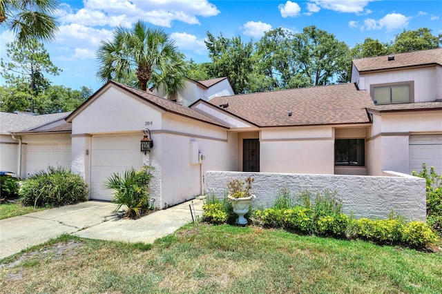 2815 Spyglass Cv, Longwood, FL 32779 - view of front of house featuring a garage, concrete driveway, stucco siding, and roof with shingles