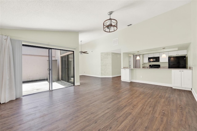 2815 Spyglass Cv, Longwood, FL 32779 - unfurnished living room with dark wood-type flooring, a chandelier, high vaulted ceiling, and ceiling fan