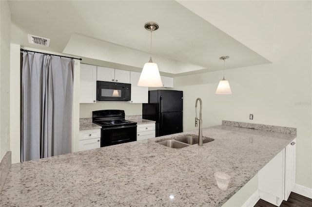 2815 Spyglass Cv, Longwood, FL 32779 - kitchen featuring black appliances, a peninsula, white cabinets, pendant lighting, and light stone countertops