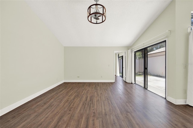 2815 Spyglass Cv, Longwood, FL 32779 - unfurnished living room featuring vaulted ceiling, dark wood finished floors, and a chandelier