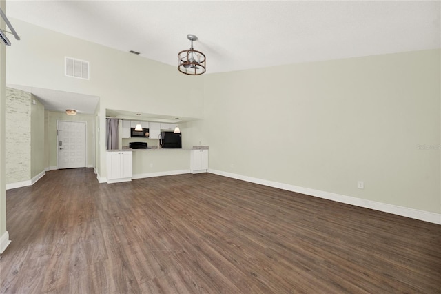 2815 Spyglass Cv, Longwood, FL 32779 - unfurnished living room featuring a chandelier and dark wood-style flooring