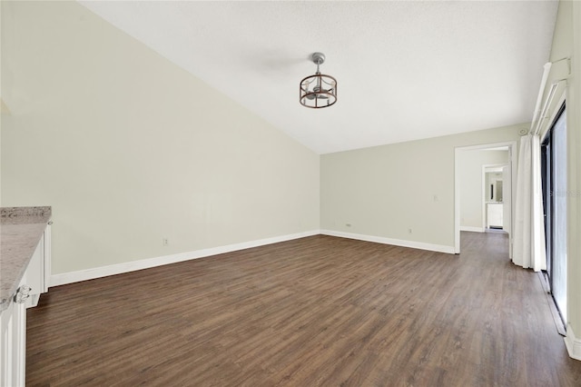 2815 Spyglass Cv, Longwood, FL 32779 - unfurnished living room with lofted ceiling, dark wood finished floors, a chandelier, and plenty of natural light