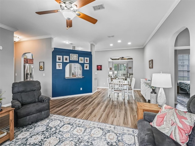 16863 SE 110th Court Rd, Summerfield, FL 34491 - living area featuring arched walkways, ceiling fan, ornamental molding, wood finished floors, and recessed lighting