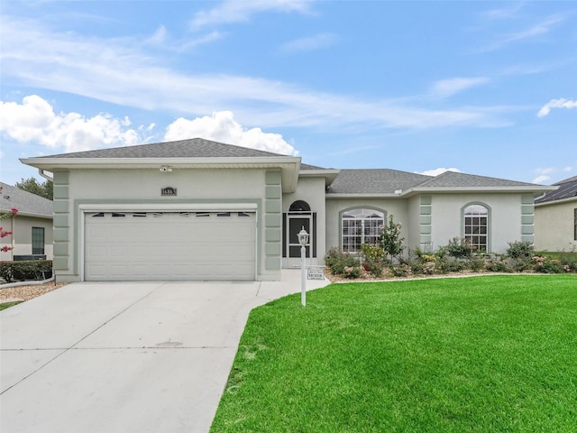 16863 SE 110th Court Rd, Summerfield, FL 34491 - ranch-style home with stucco siding, a garage, a front yard, and concrete driveway