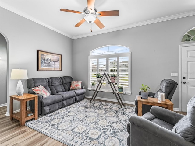 16863 SE 110th Court Rd, Summerfield, FL 34491 - living area featuring light wood finished floors, a ceiling fan, arched walkways, and ornamental molding