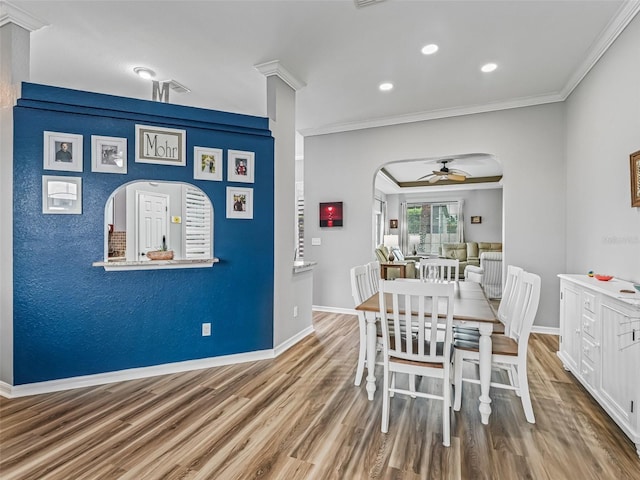16863 SE 110th Court Rd, Summerfield, FL 34491 - dining room featuring a ceiling fan, wood finished floors, arched walkways, crown molding, and recessed lighting