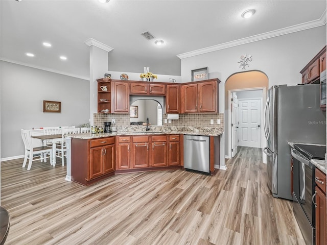 16863 SE 110th Court Rd, Summerfield, FL 34491 - kitchen with appliances with stainless steel finishes, ornamental molding, decorative backsplash, light wood finished floors, and light stone countertops