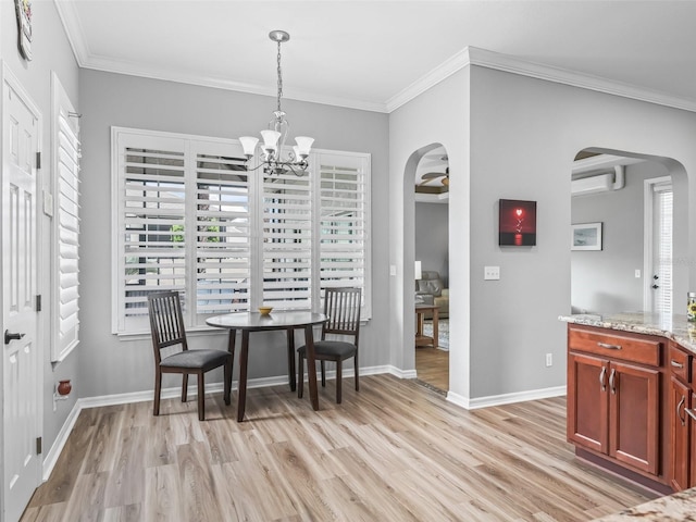 16863 SE 110th Court Rd, Summerfield, FL 34491 - dining area with arched walkways, light wood finished floors, a wall mounted air conditioner, ornamental molding, and a chandelier
