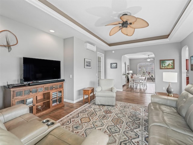 16863 SE 110th Court Rd, Summerfield, FL 34491 - living area featuring arched walkways, ceiling fan, a wall mounted air conditioner, and a raised ceiling