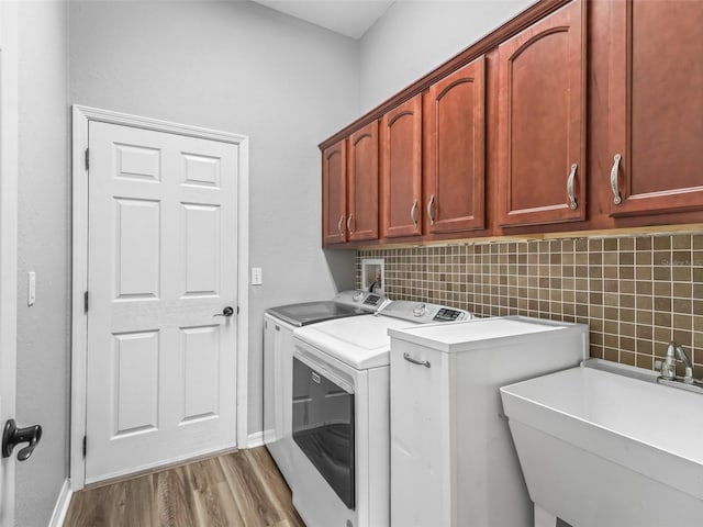 16863 SE 110th Court Rd, Summerfield, FL 34491 - laundry area with cabinet space, independent washer and dryer, and wood finished floors