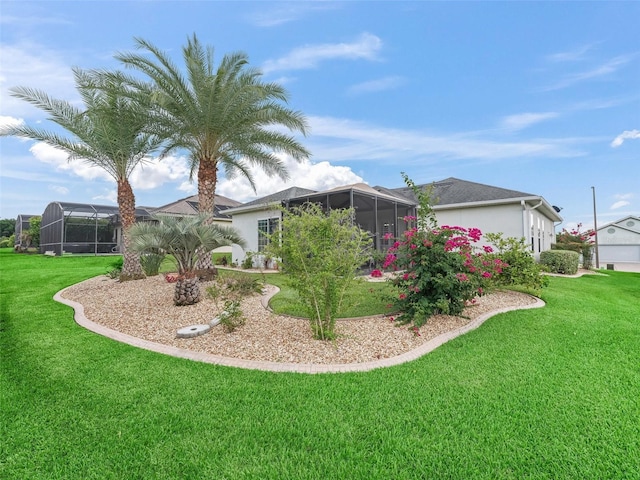 16863 SE 110th Court Rd, Summerfield, FL 34491 - back of property with a yard, stucco siding, a sunroom, and a lanai