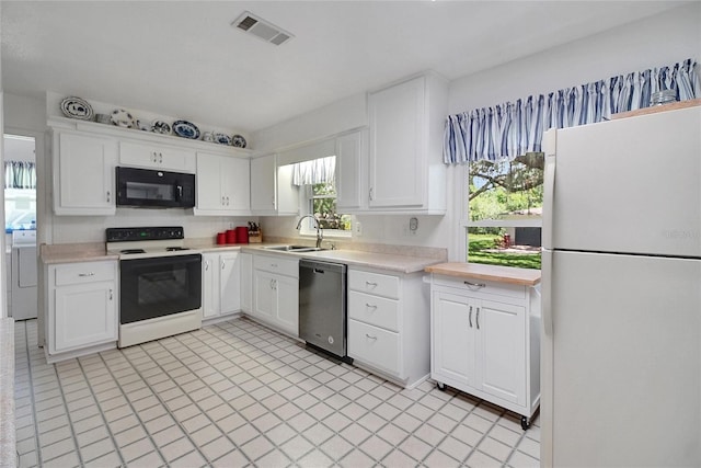 5319 Eagles Nest Rd, Fruitland Park, FL 34731 - kitchen with white appliances, light countertops, white cabinetry, and washer / clothes dryer