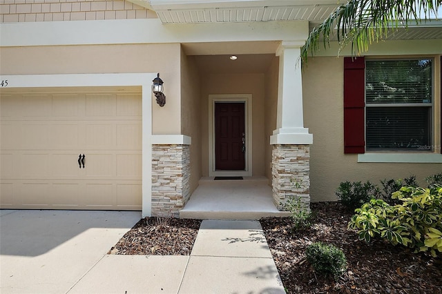 20945 Oldenburg Loop, Mount Dora, FL 32757 - doorway to property with stucco siding, stone siding, a garage, and concrete driveway