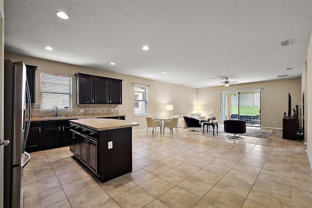 20945 Oldenburg Loop, Mount Dora, FL 32757 - kitchen with freestanding refrigerator, open floor plan, wood counters, light tile patterned floors, and recessed lighting