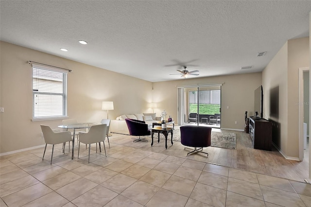 20945 Oldenburg Loop, Mount Dora, FL 32757 - living room featuring plenty of natural light, a textured ceiling, a ceiling fan, recessed lighting, and light tile patterned flooring