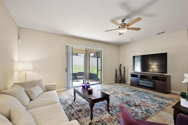 20945 Oldenburg Loop, Mount Dora, FL 32757 - living area with a ceiling fan and wood finished floors
