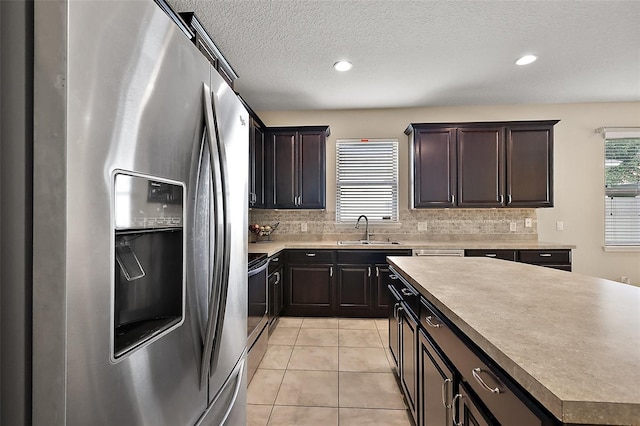 20945 Oldenburg Loop, Mount Dora, FL 32757 - kitchen with appliances with stainless steel finishes, backsplash, light tile patterned flooring, recessed lighting, and a textured ceiling