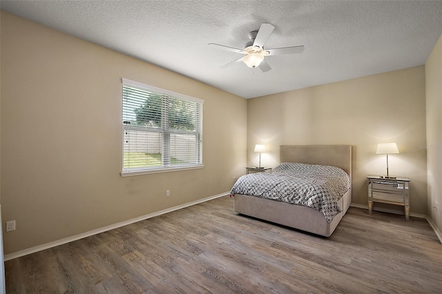 20945 Oldenburg Loop, Mount Dora, FL 32757 - bedroom with wood finished floors, a textured ceiling, and ceiling fan