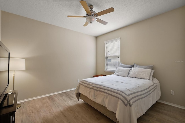 20945 Oldenburg Loop, Mount Dora, FL 32757 - bedroom featuring wood finished floors, a ceiling fan, and a textured ceiling