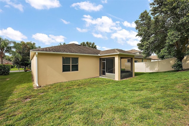 20945 Oldenburg Loop, Mount Dora, FL 32757 - rear view of property featuring stucco siding and a sunroom