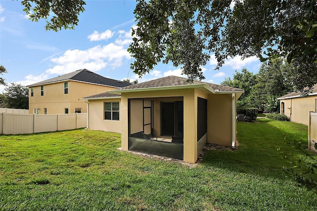 20945 Oldenburg Loop, Mount Dora, FL 32757 - back of property featuring a sunroom, stucco siding, and roof with shingles