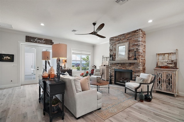 622 W 11th Ave, Mount Dora, FL 32757 - living area with a ceiling fan, light wood-style flooring, a fireplace, crown molding, and recessed lighting