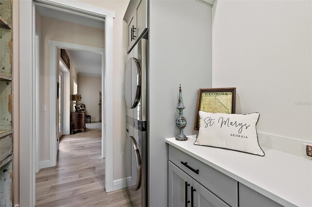 622 W 11th Ave, Mount Dora, FL 32757 - laundry room featuring stacked washer and clothes dryer and light wood-style flooring