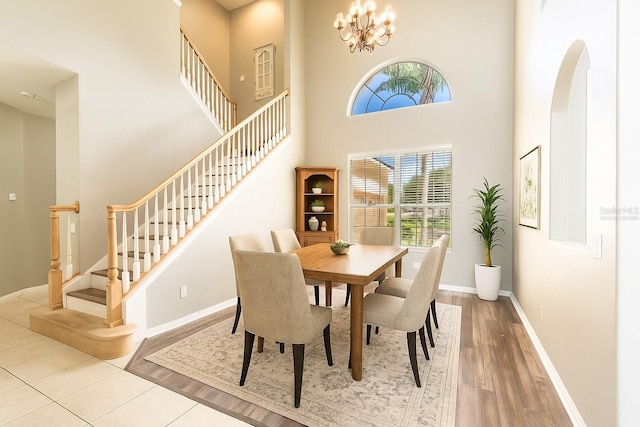 4548 Barrister Dr, Clermont, FL 34711 - dining room with stairway, a towering ceiling, arched walkways, wood finished floors, and a chandelier