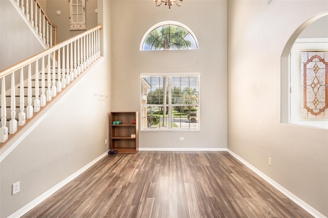 4548 Barrister Dr, Clermont, FL 34711 - foyer with wood finished floors, stairway, arched walkways, and a high ceiling