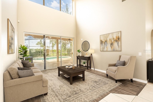 4548 Barrister Dr, Clermont, FL 34711 - living room featuring a towering ceiling, wood finished floors, and arched walkways