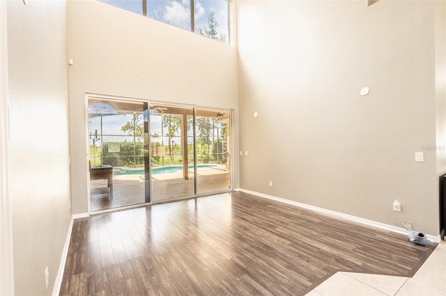 4548 Barrister Dr, Clermont, FL 34711 - unfurnished living room featuring wood finished floors and a high ceiling