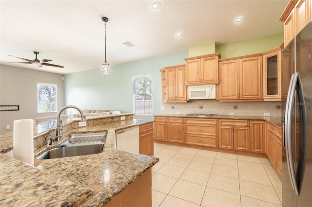 4548 Barrister Dr, Clermont, FL 34711 - kitchen with white appliances, ceiling fan, backsplash, light tile patterned flooring, and pendant lighting