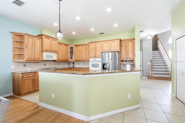 4548 Barrister Dr, Clermont, FL 34711 - kitchen featuring stainless steel appliances, open shelves, a large island with sink, backsplash, and recessed lighting