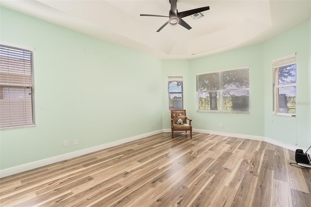 4548 Barrister Dr, Clermont, FL 34711 - spare room with wood finished floors, a ceiling fan, and a raised ceiling