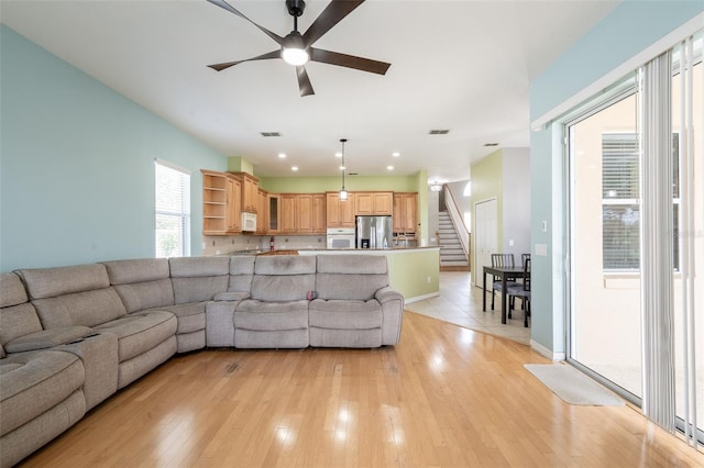 4548 Barrister Dr, Clermont, FL 34711 - living area with ceiling fan, stairs, light wood finished floors, and recessed lighting