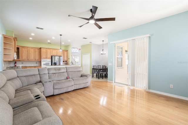 4548 Barrister Dr, Clermont, FL 34711 - living area featuring light wood finished floors, recessed lighting, a ceiling fan, a chandelier, and healthy amount of natural light