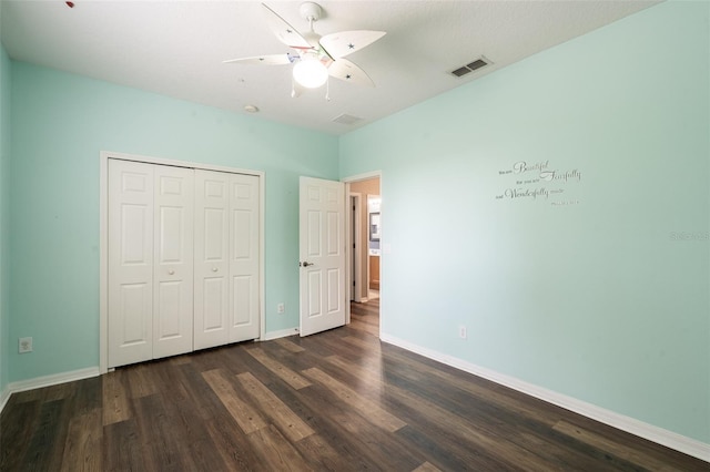 4548 Barrister Dr, Clermont, FL 34711 - unfurnished bedroom with dark wood finished floors, a closet, and ceiling fan