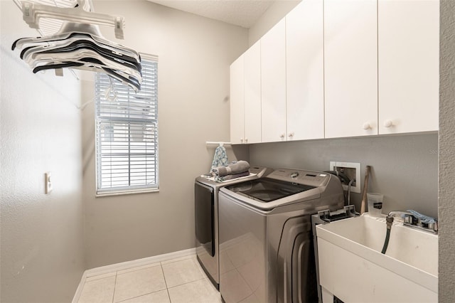 4548 Barrister Dr, Clermont, FL 34711 - washroom with cabinet space, separate washer and dryer, and tile patterned floors