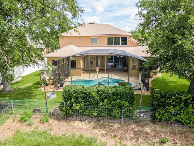 4548 Barrister Dr, Clermont, FL 34711 - rear view of property featuring a fenced backyard, a patio area, stucco siding, and glass enclosure